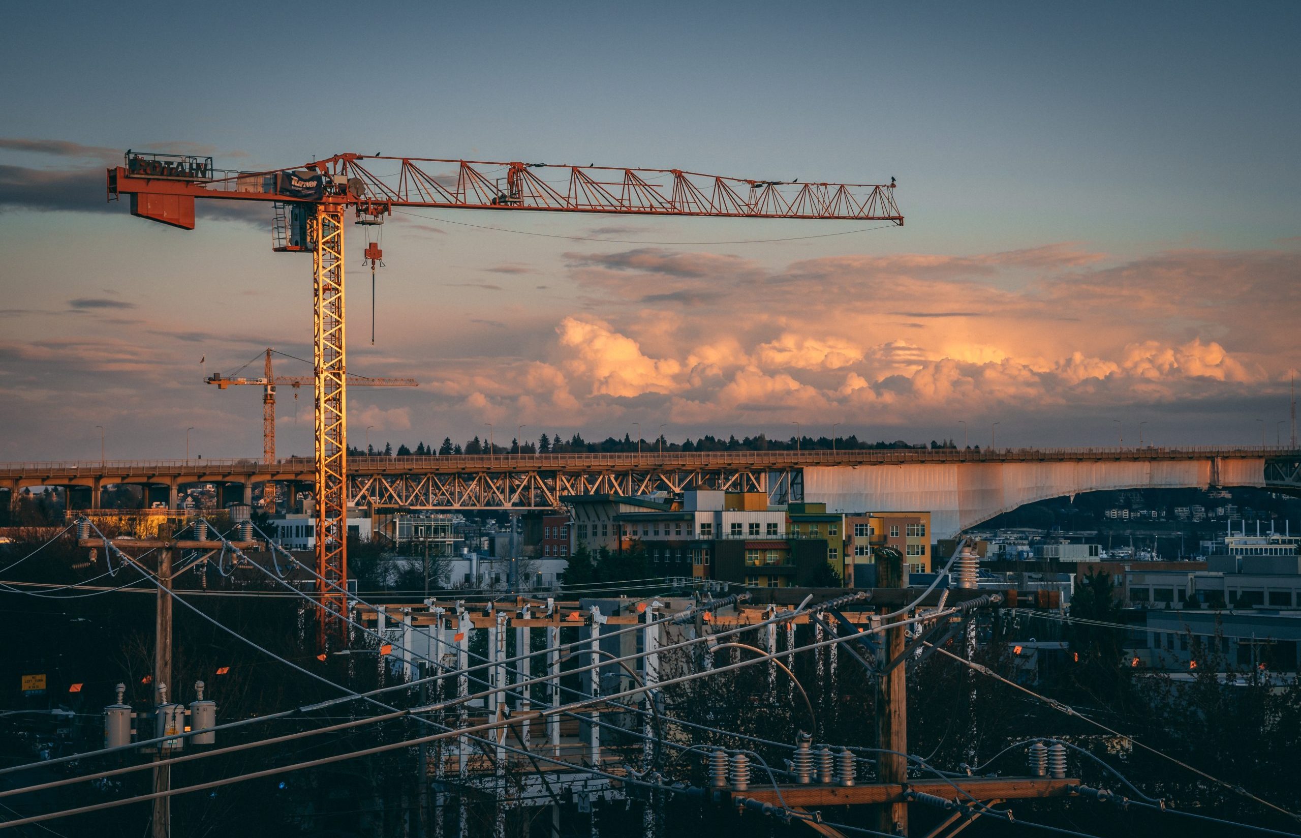 A beautiful view of a construction site in a city during sunset